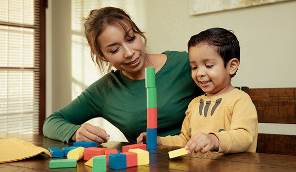 Mother and child playing with building blocks